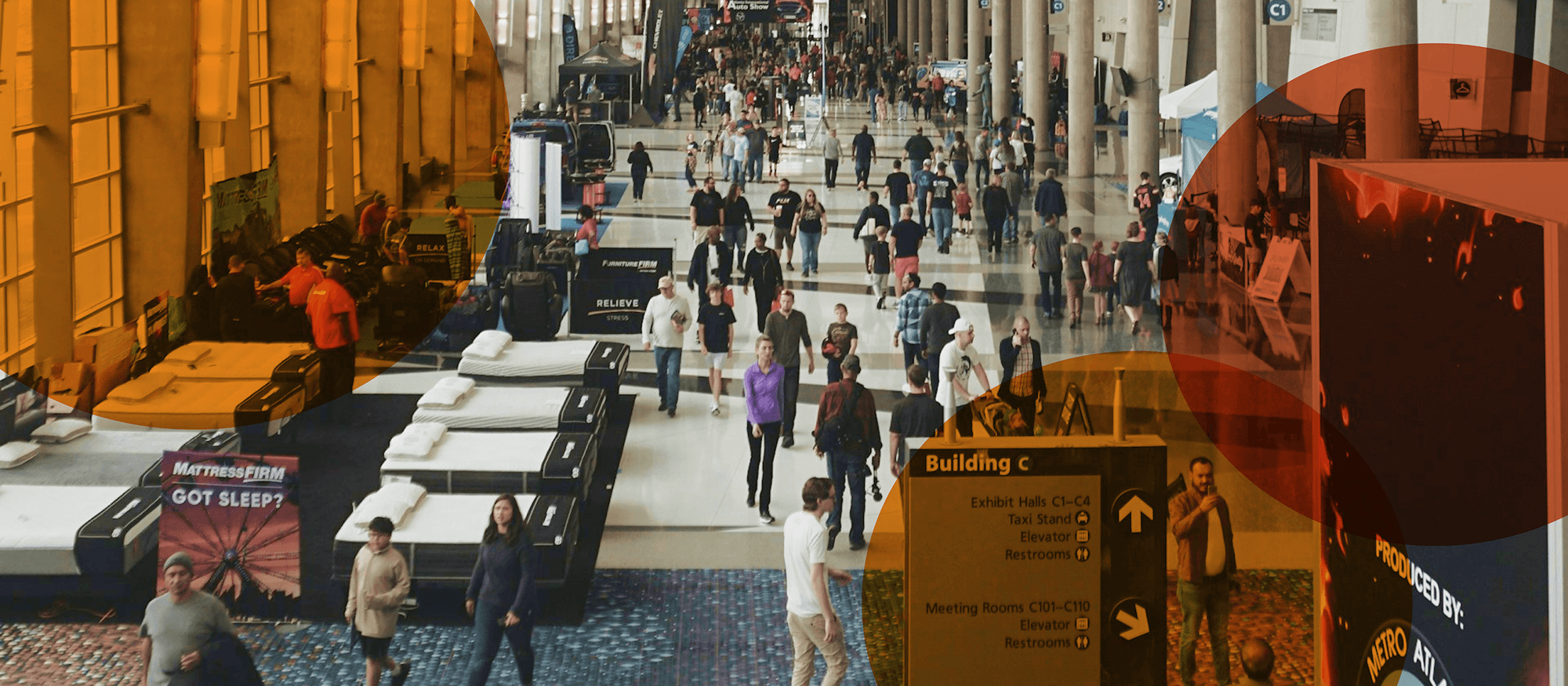 Busy large event showing people walking around and exploring event booths.